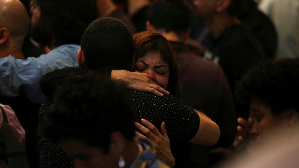 Supporters of Fernando Haddad, presidential candidate of Brazil's leftist Workers Party (PT), embrace each other after Jair Bolsonaro was announced as winner