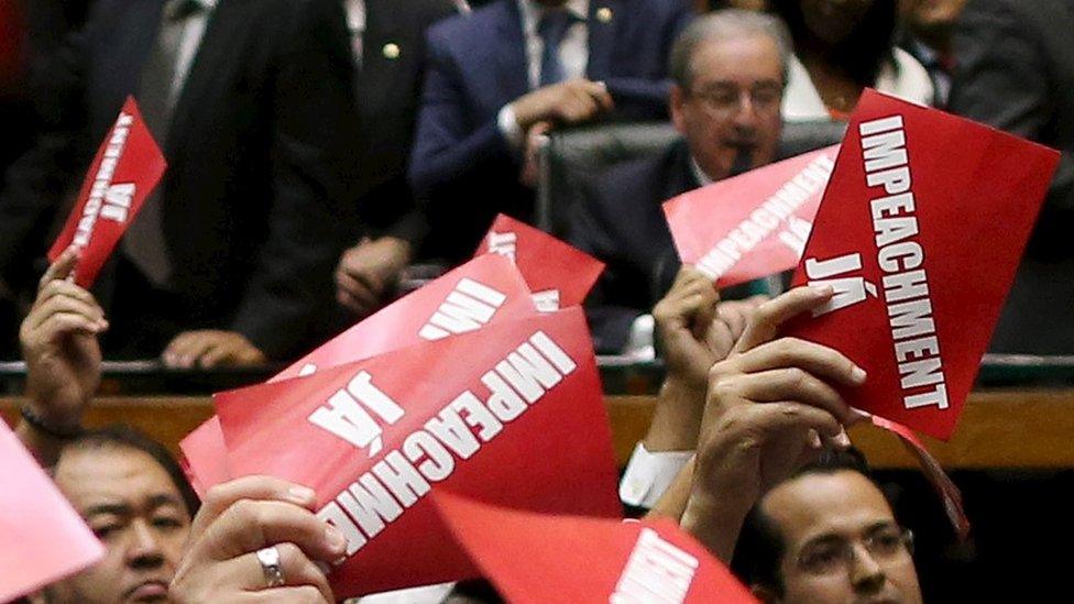 Opposition deputies hold papers that read, " Impeachment now!" during ballot to appoint a committee to report on whether to impeach Brazil"s President Dilma Rousseff