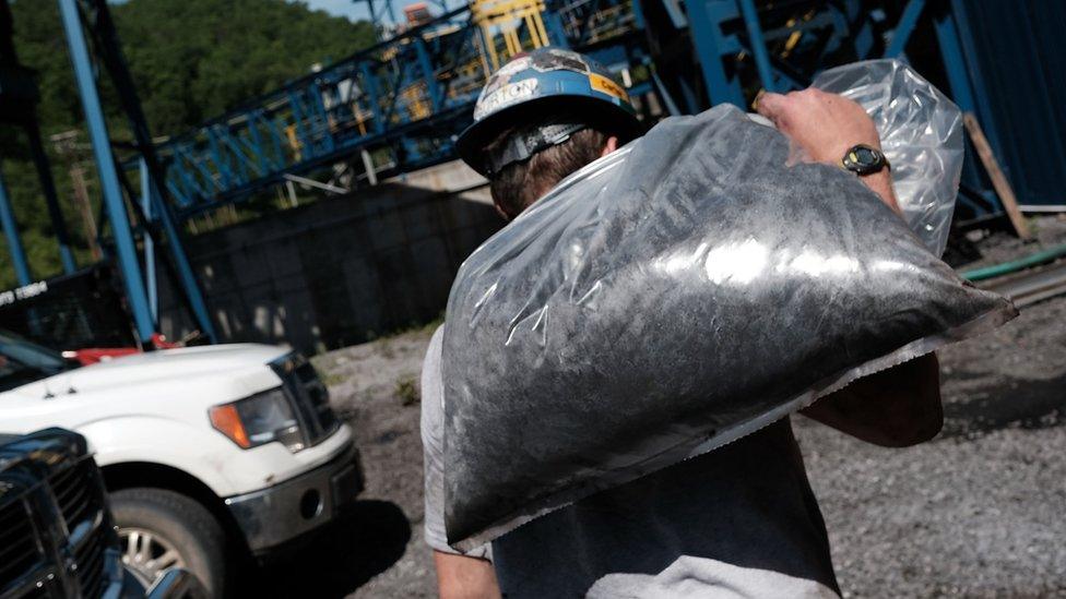 man with bag of coal