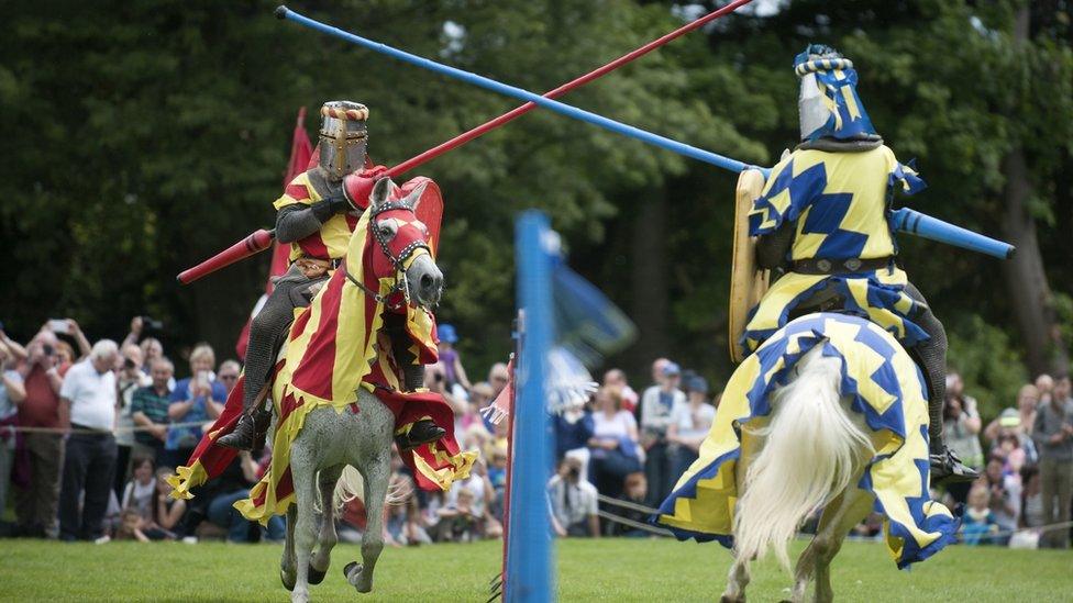 Two knights joust at a modern re-enactment show