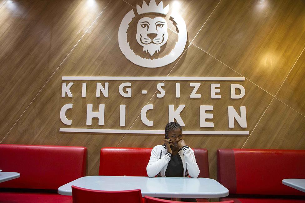 Woman on the phone in a fast food restaurant