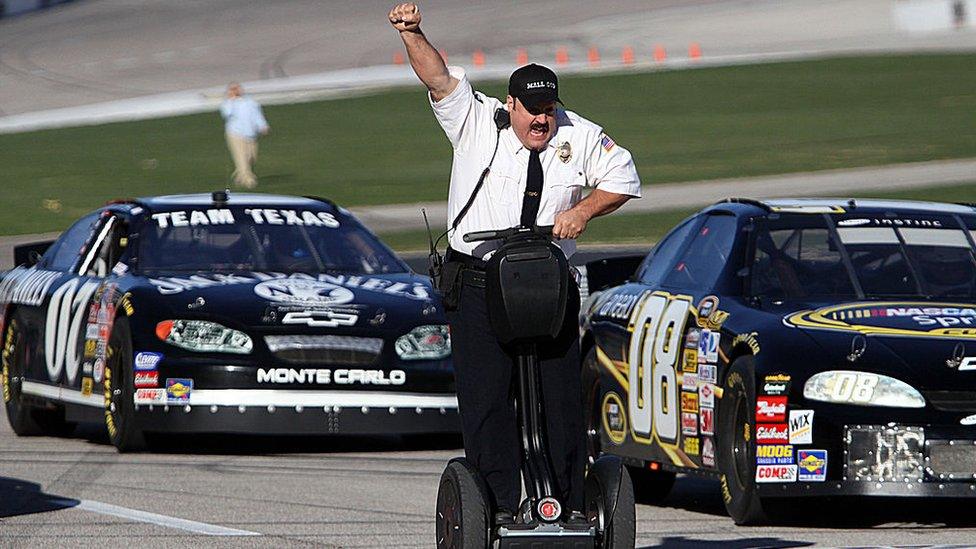 Actor and comedian Kevin James celebrates while racing NASCAR stock cars with his Segway to promote the release of his new movie, "Paul Blart: Mall Cop".