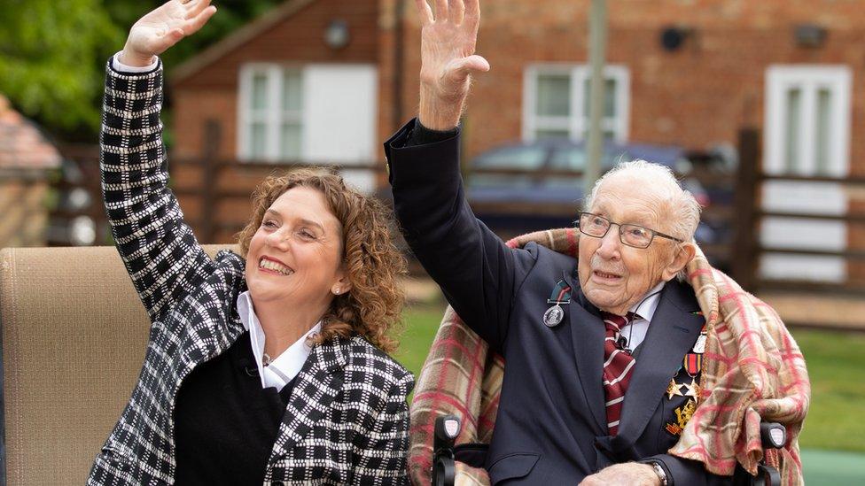 Captain Tom and his daughter Hannah wave