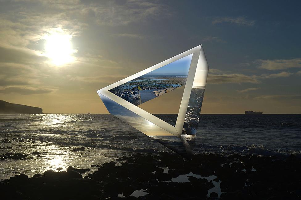 A shot of a triangular art piece in the middle of the ocean