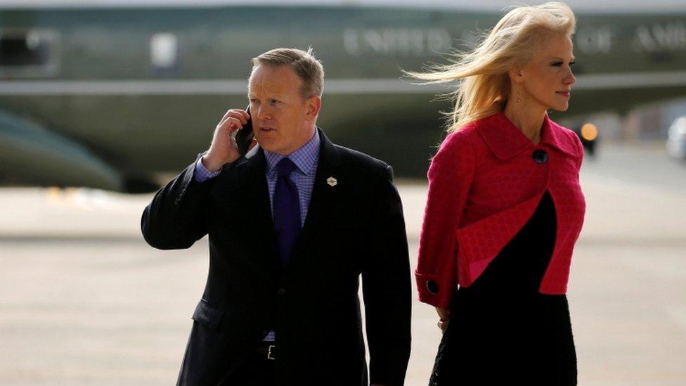 White House press secretary Sean Spicer and Mr Trump's aide Kellyanne Conway wait for the president at an air force base in January