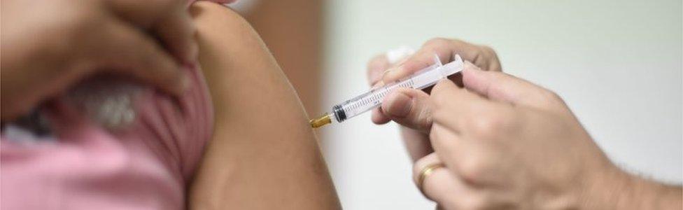 A woman receives a yellow fever vaccine at a public health post in Caratinga, in the south-eastern state of Minas Gerais, Brazil, on January 13, 2017.