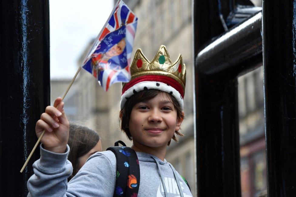 A well-wisher outside St Giles' Cathedral, Edinburgh, ahead of the National Service of Thanksgiving and Dedication for King Charles III and Queen Camilla, and the presentation of the Honours of Scotland