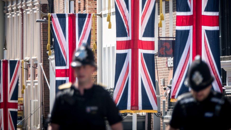 Police officers patrol close to Windsor Castle ahead of the royal wedding