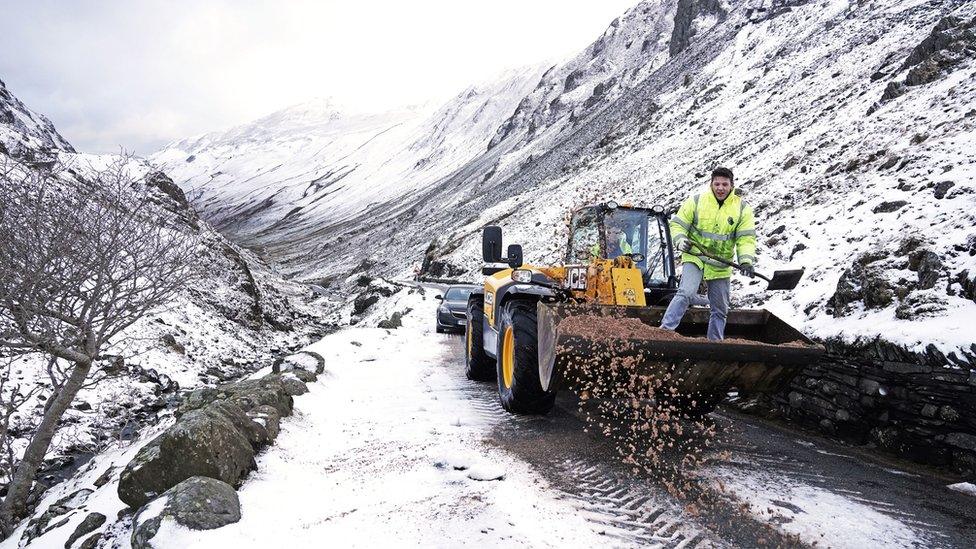 A tractor clears snow from a road near Honister Slate Mine in the lake district, Cumbria, UK