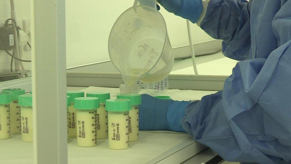 Breast milk being poured into bottles