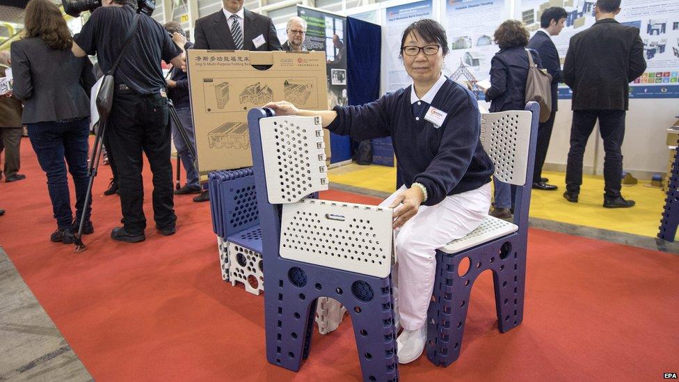 Inventor holding collapsible furniture