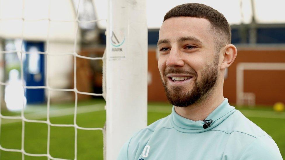 Conor Chaplin, Ipswich Town's number 10 leaning up against a goalpost at the club's training ground