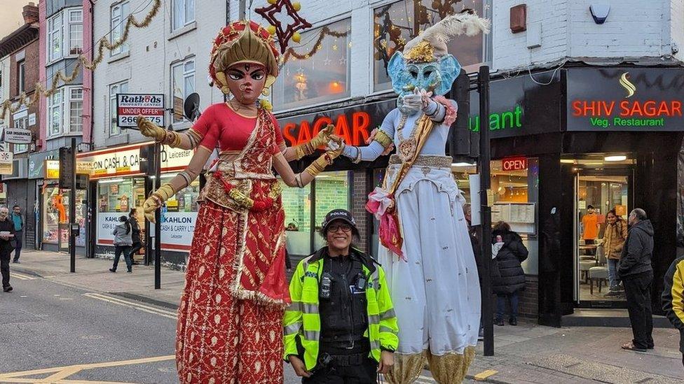 A police officer with two performers