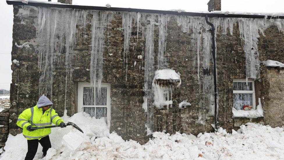 Mags Turnbull from Browfoot Cottage in Bowerdale in Cumbria digs herself out after being snowed in for three days