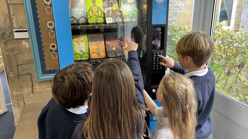 children using a book vending machine