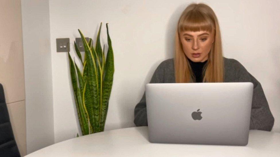 Heather MacFarlane sat at a table with her laptop in front of her