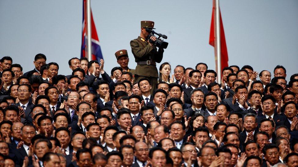 A soldier films the military parade