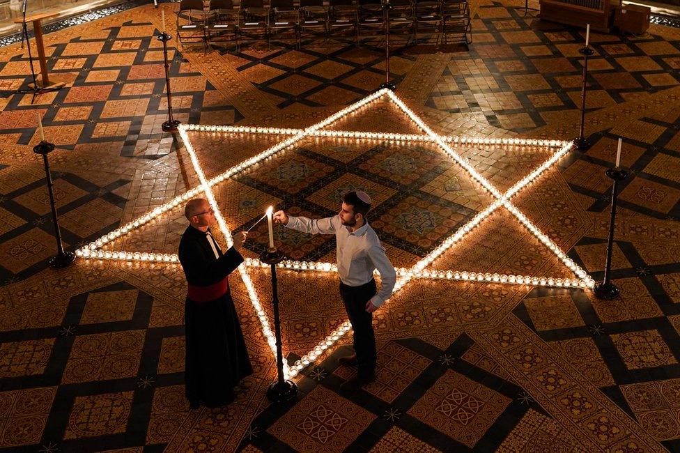 The Reverend Canon Dr Christopher Collingwood and Joshua Daniels from University of York Jewish Society light 600 candles