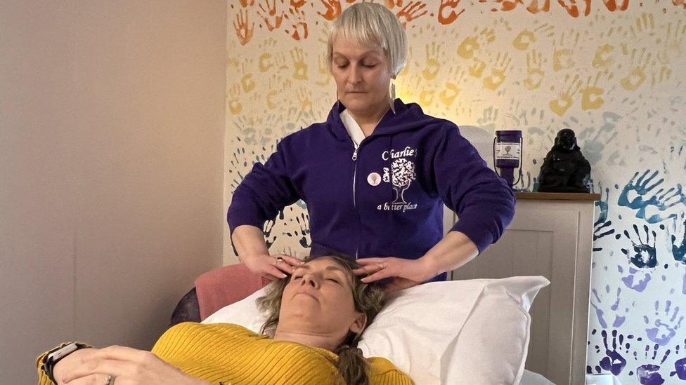 Faye Czajkowski-Davis receiving a head massage from Jo Sutherland