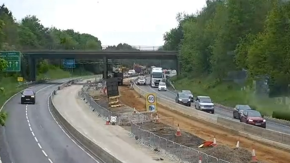 A black SUV driving on a closed-off A12