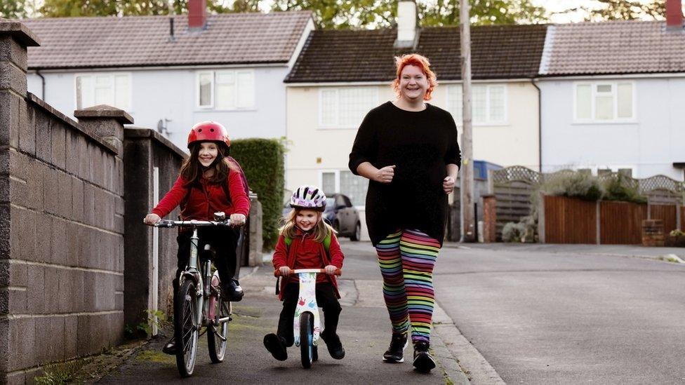 Laura, a mum of two, walking to school with her children