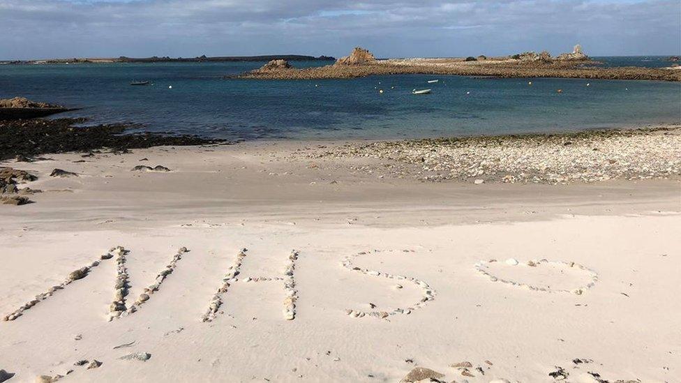 "NHS" drawn on beach