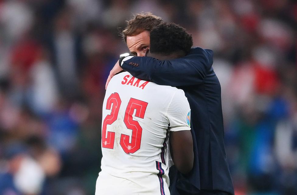 Bukayo Saka of England is consoled by Gareth Southgate, Head Coach of England following defeat in the UEFA Euro 2020 Championship Final between Italy and England at Wembley Stadium on July 11, 2021 in London, England.