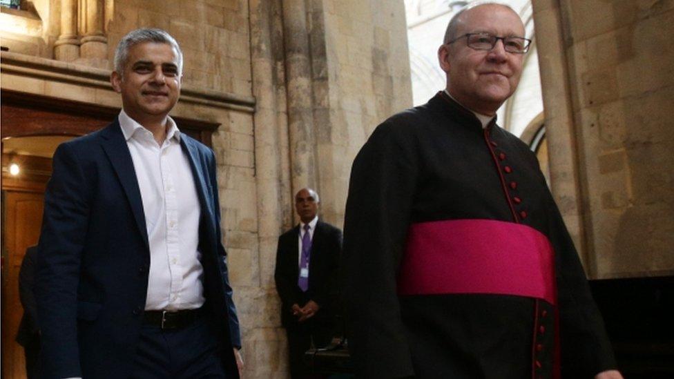 Sadiq Khan walks along side the Dean of Southwark Cathedral, The Very Reverend Andrew Nunn