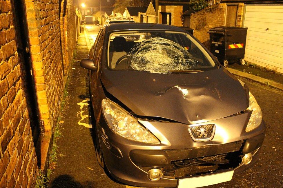 Youssaf's car showing smashed windscreen and bonnet dent