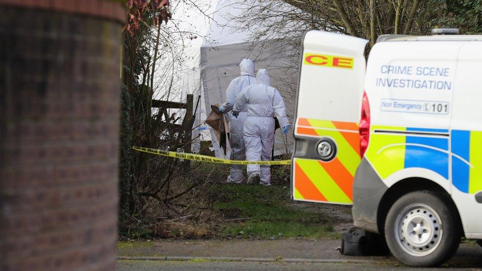 Police scientific officers work at a crime scene in Alness Drive