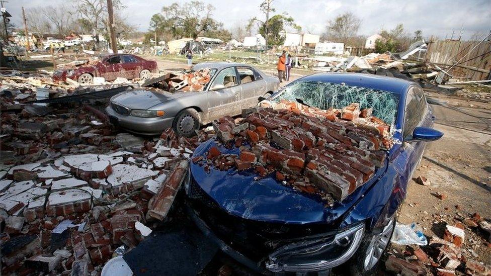 Cars are covered with bricks after a tornado touched down in New Orleans, Louisiana.