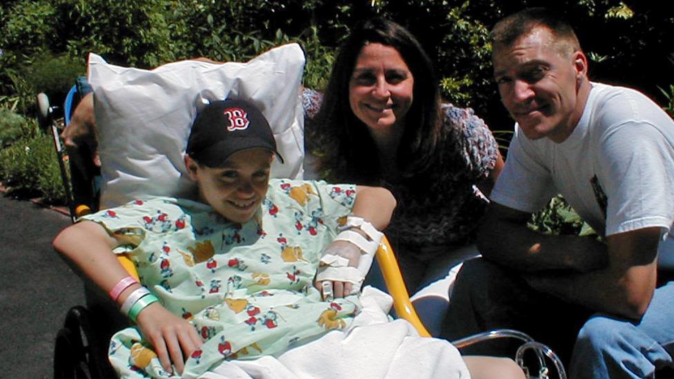 Luke Massella as a boy with his parents