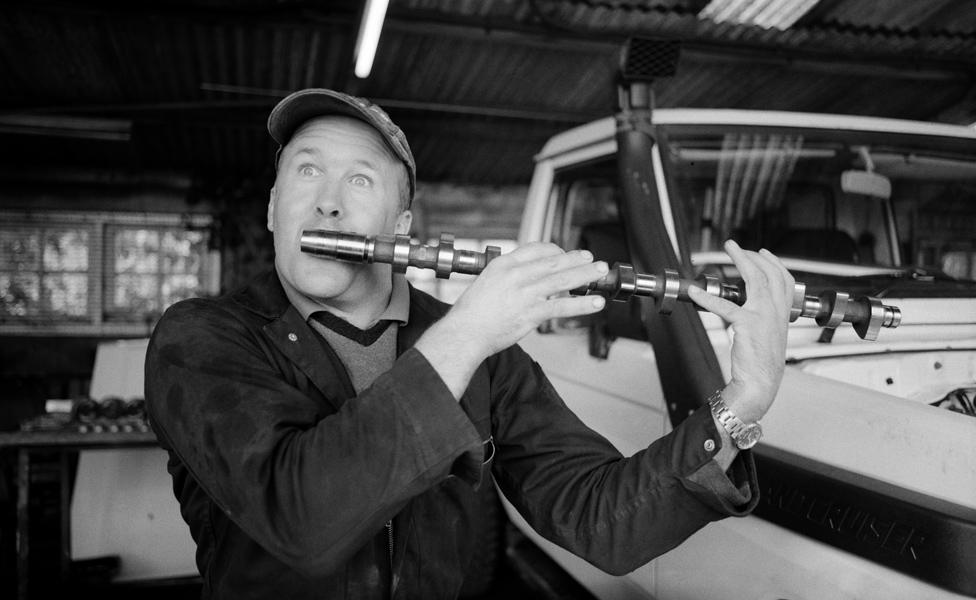 Man pretending a camshaft is a flute