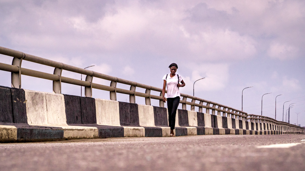 A woman walking on the Third Mainland Bridge in Lagos, Nigeria