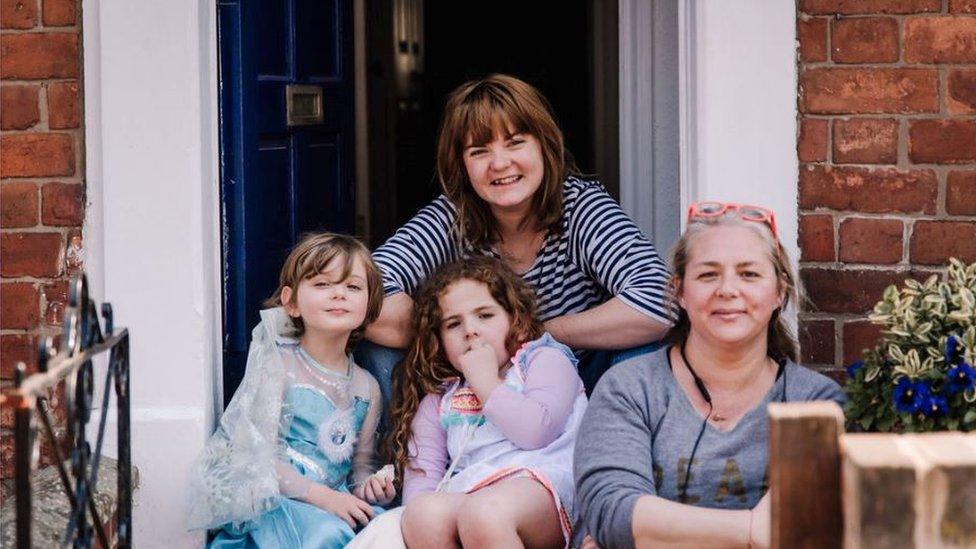 A family sitting on their doorstep