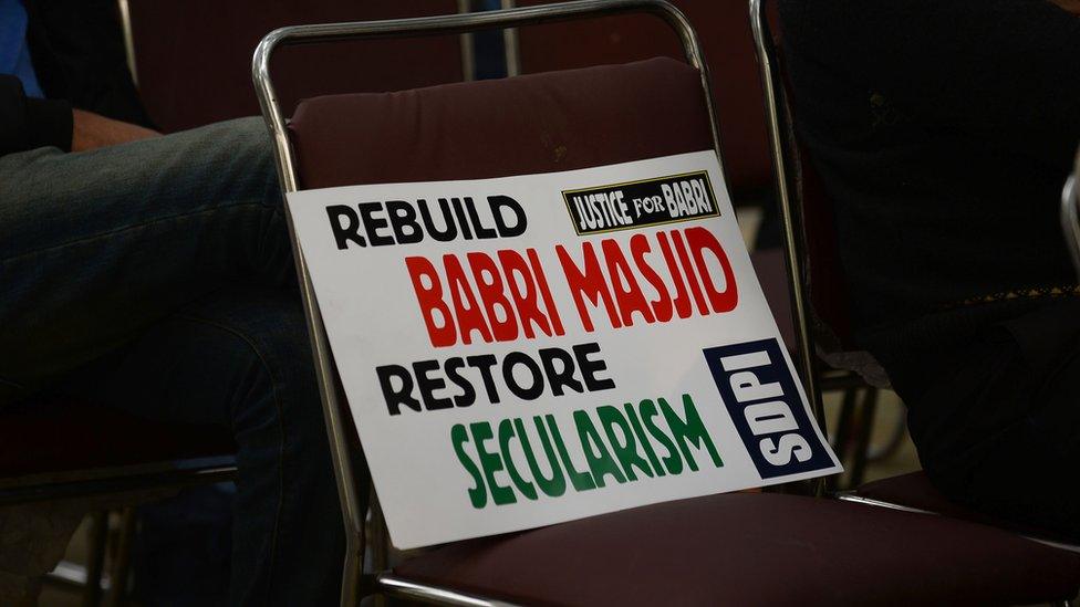 A placard is seen on a chair during a protest by Indian activists to mark the 24th anniversary of the destruction of the Babri Mosque in New Delhi on December 6,2016.