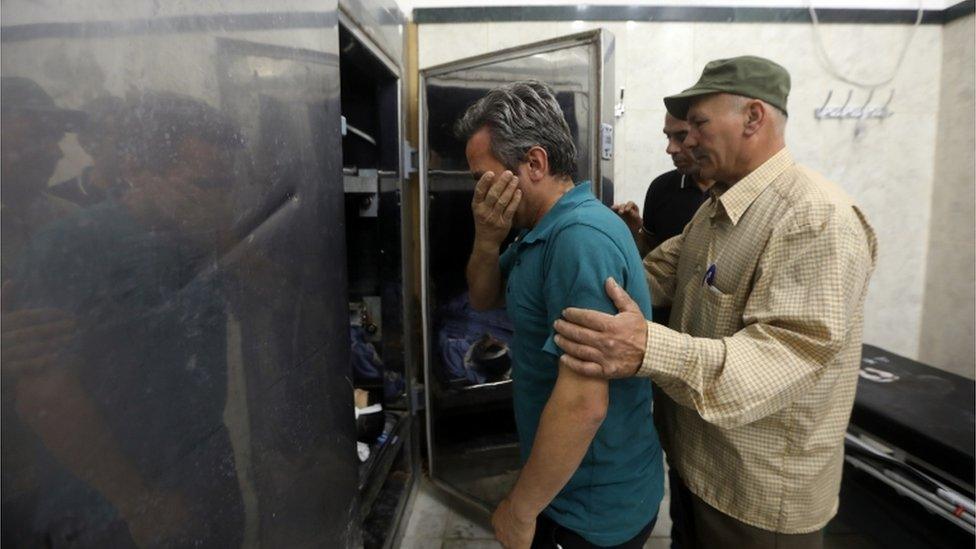 Relatives of the killed Palestinian security officers weep in the morgue