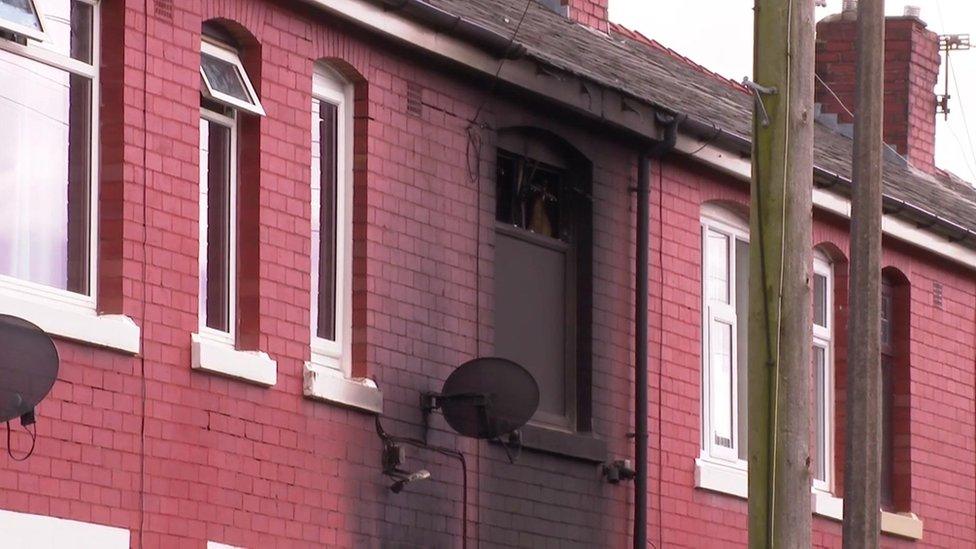 house with scorch marks around window