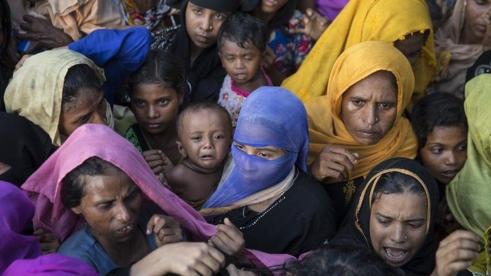 Rohingya reach out for clothing and food on 15 September 2017 in Tankhali, Bangladesh