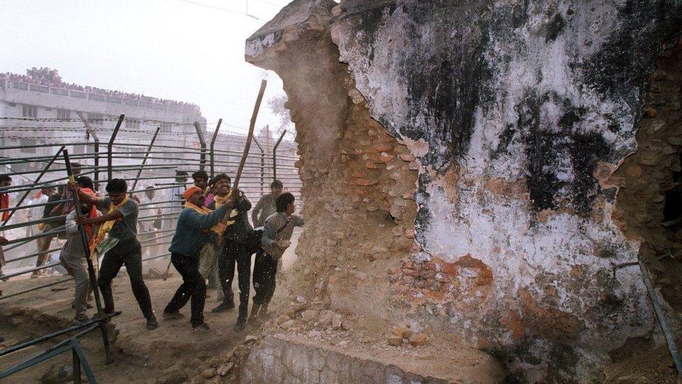 Right-wing Hindu mobs attack the wall of the mosque with iron rods on 6 December, 1992