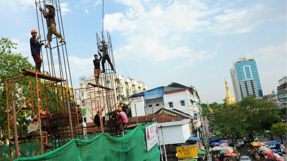 Construction work in Yangon, scaffolding, pagoda in background