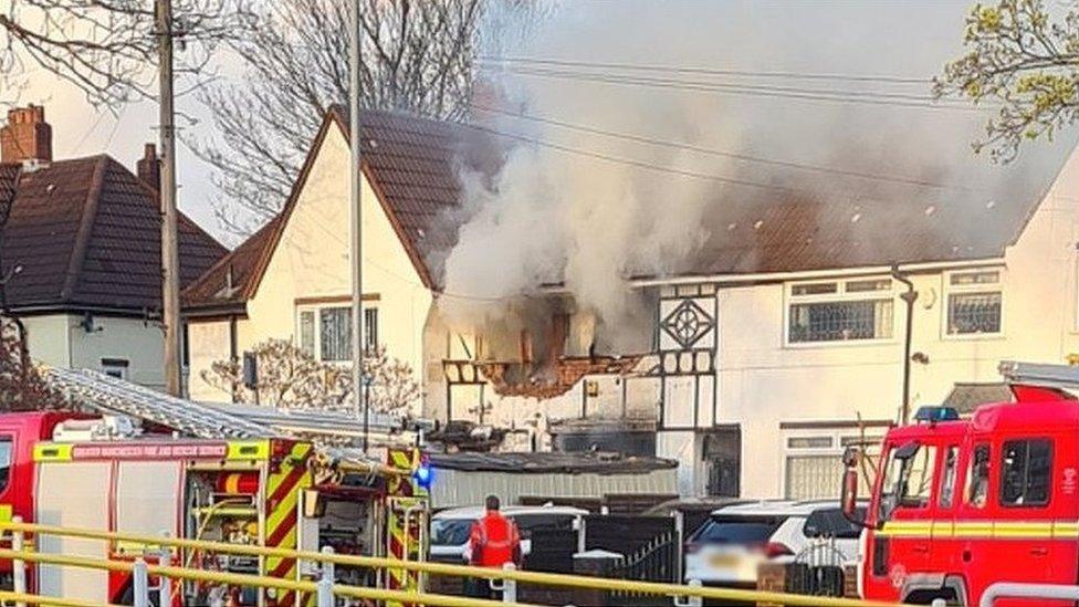 Smoke billowing out from suspected house explosion