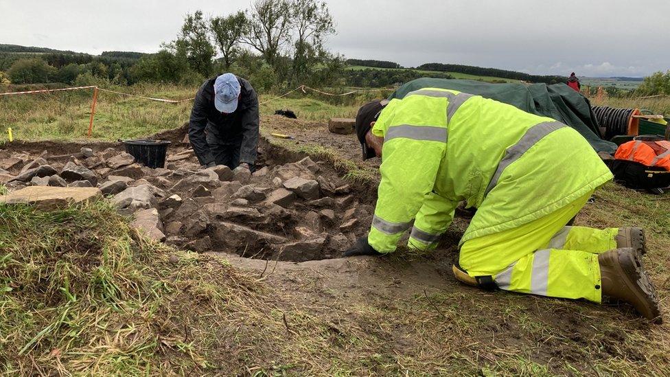 Volunteers excavate around an area where a spiral staircase is believed to have been located.