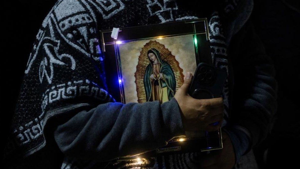 A Pilgrim holds an image of the Virgin of Guadalupe in the square of the Basilica of Our Lady of Guadalupe during the annual Virgin of Guadalupe feast day, in Mexico City, Mexico, December 12, 2023.