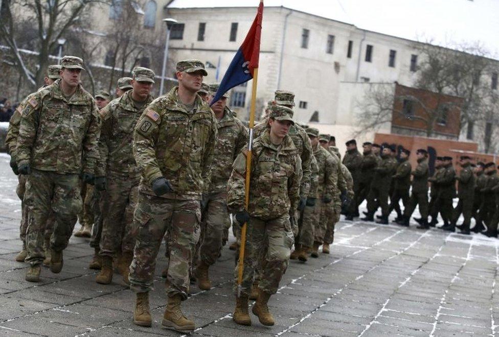 US and Polish army soldiers attend an official welcoming ceremony for U.S. troops deployed to Poland as part of NATO build-up in eastern Europe