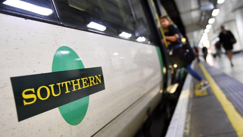 Passenger boarding Southern Rail train at Victoria Station.