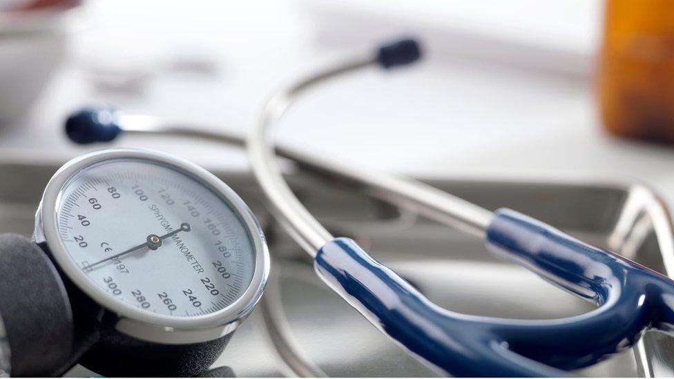 Medical equipment. Sphygmomanometer (left) and stethoscope (right) on a metal tray.