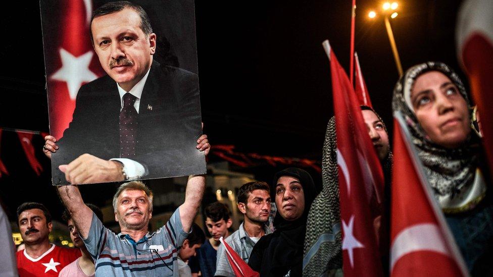 Man holds up photo of Recep Tayyip Erdogan during rally in Taksim square in Istanbul. 22 July 2016