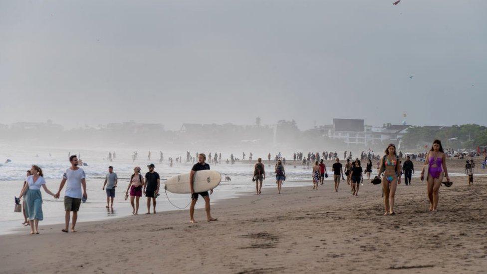 BALI, INDONESIA - 2022/09/17: Large crowds of tourists and expats are seen at Seminyak Beach. Tourism in Indonesia is picking up after the covid 19 pandemic.