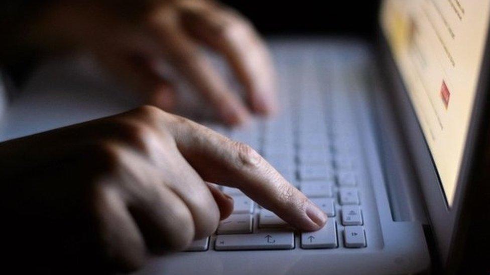 Undated file photo of a person using a laptop computer keyboard.